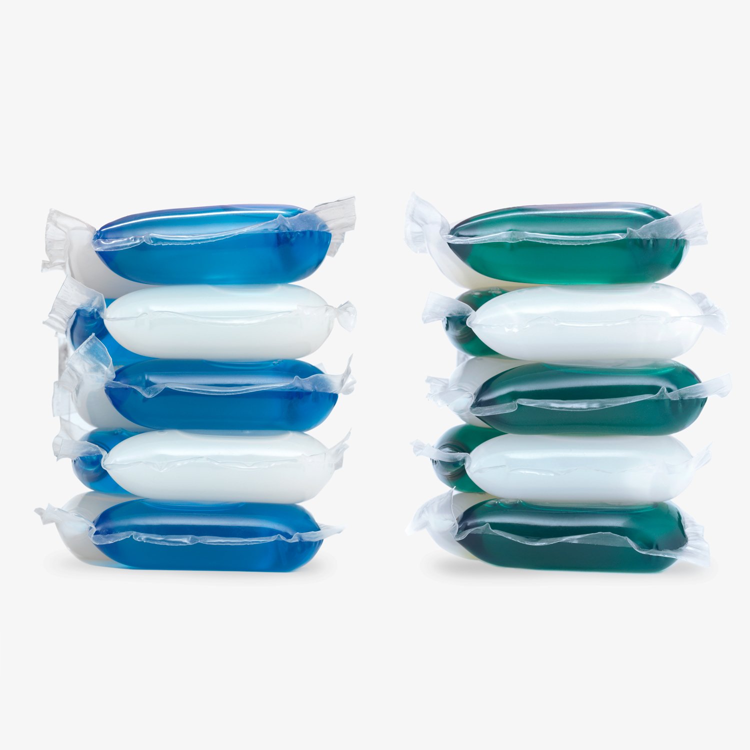 Two stacks of laundry detergent pods, each with four pods in blue, green, and white hues, are arranged against a plain white background—a clean aesthetic reflecting the ethos of a strategically‑led branding studio.