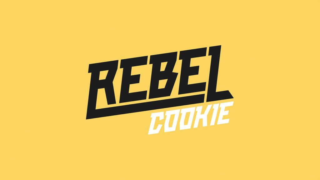 Bold black text "REBEL" above slanted white text "COOKIE" on a solid yellow background. The modern, dynamic font embodies Creative that Converts, capturing energetic and rebellious vibes to inspire growth by design.